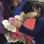 girl hugging puppet